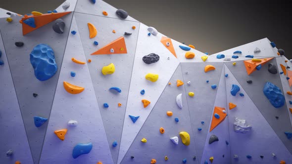 Indoor bouldering wall with colorful climbing holds. Gym indoor extreme training alt