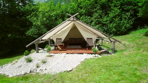 Tracking shot of a glamping tent in an eco camping in Slovenia. alt