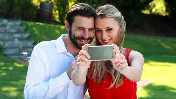 Couple taking selfie with mobile phone in outdoor restaurant 4k alt