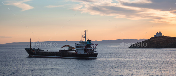 Mediterranean sea. Beautiful sunset and a lighthouse at Kea island, Greece.  Stock Photo by rawf8