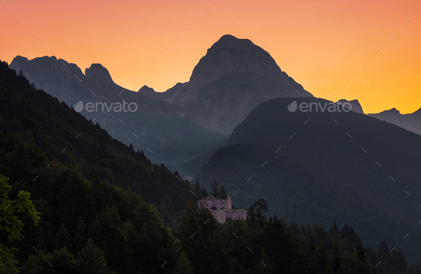 Castle below the Mangart mountain at sunrise - Stock Photo - Images