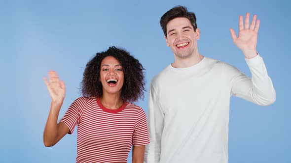 Interracial Friendly Couple  White Man and African Woman Waving Hands  Hello alt