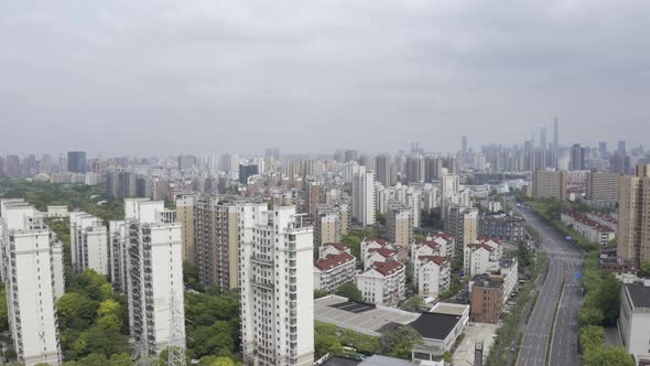 aerial pan shot of an empty street with Pudong building alt