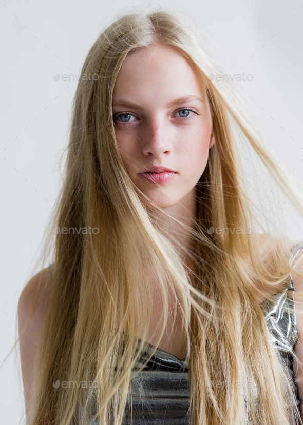 Beautiful blonde woman girl with long blond hair smooth and beauty in  silver wear Stock Photo by kiraliffe