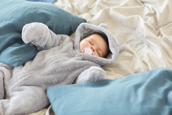 Cute Baby Sleeping on Big Comfortable Bed Stock Photo by seventyfourimages