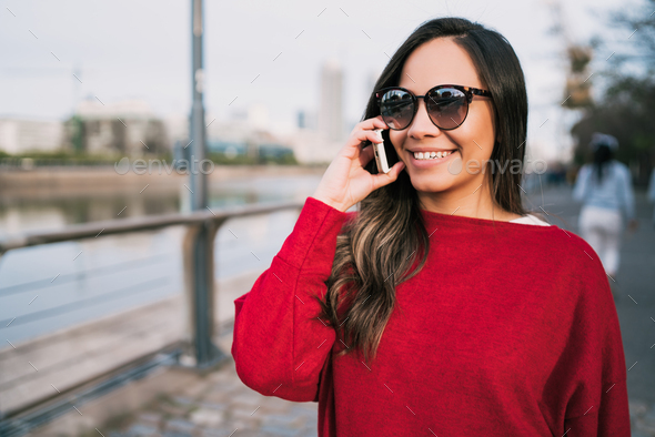 Latin woman talking on the phone.