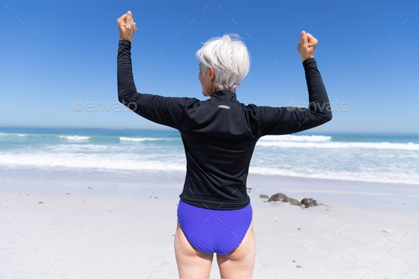 Senior Caucasian woman standing at the beach.