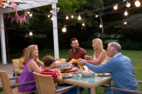 Happy Caucasian family eating together at table