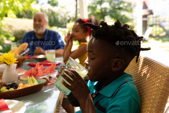 Family eating together at table - Stock Photo - Images