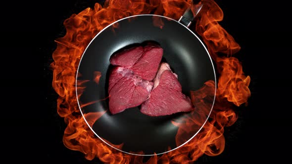 Super Slow Motion Shot of Throwing Beef Meat on Frying Pan and Fire Blast at 1000Fps alt