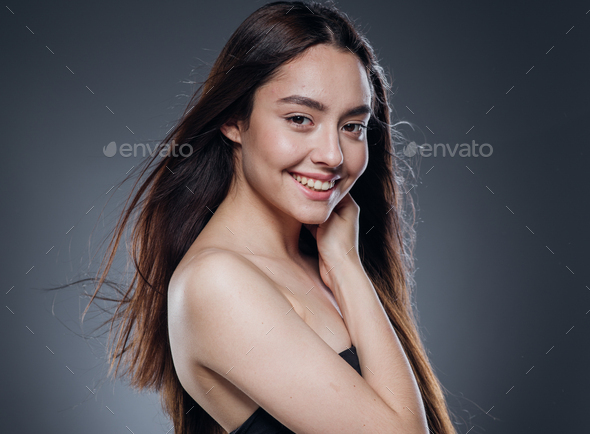 Beautiful woman smooth long hair brunette natural make up beautiful female portrait dark background