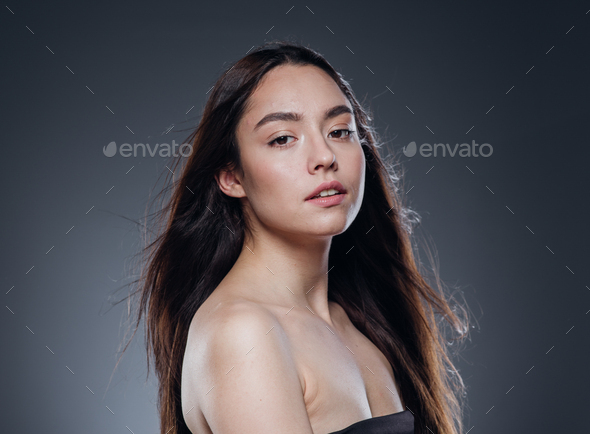 Beautiful woman smooth long hair brunette natural make up beautiful female portrait dark background