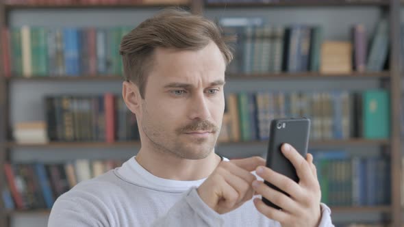Portrait of Adult Man Using Smartphone alt