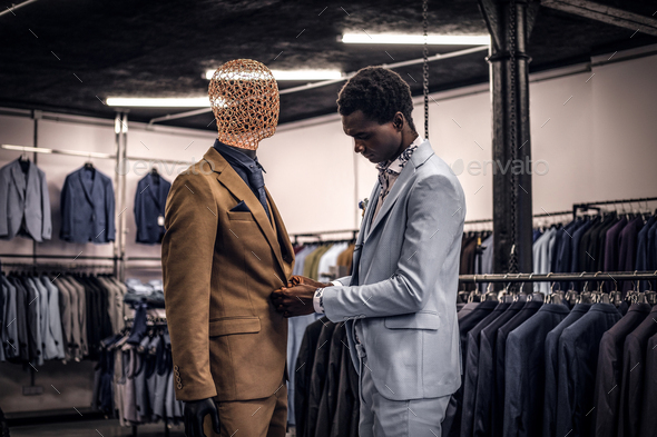 Handsome elegantly dressed African-American man in a classic menswear store