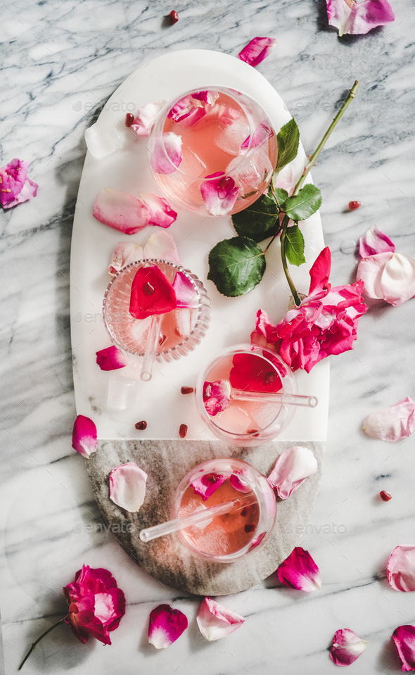 Rose lemonade with ice cubes and pink rose petals - Stock Photo - Images