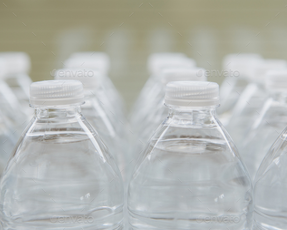Rows of water-filled plastic bottles with screw caps.