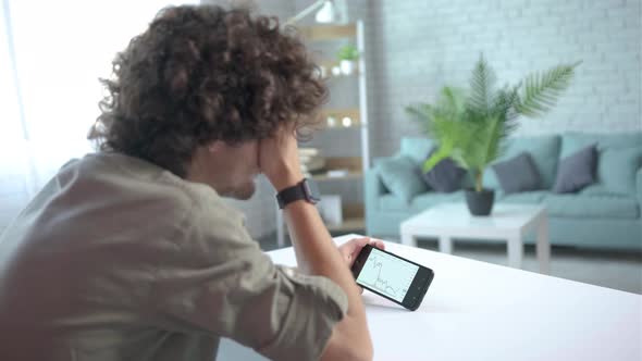 Focus on Phone Young Man Disappointed for Failed Strategy of Trading alt