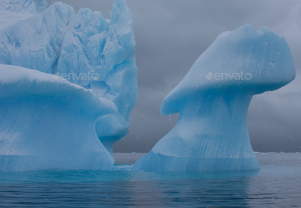 Icebergs with eroding and changing form drifting on the water, Antarctica