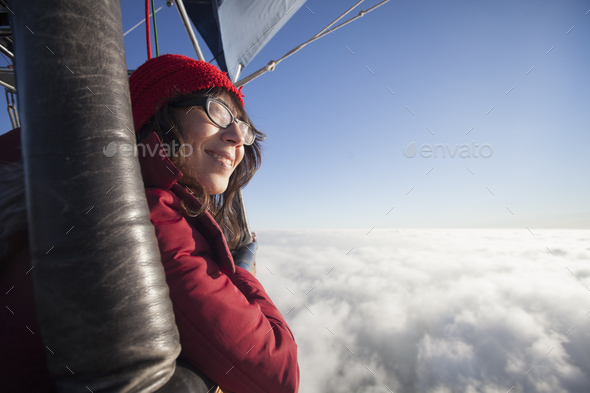 Woman travelling in a hot air balloon.
