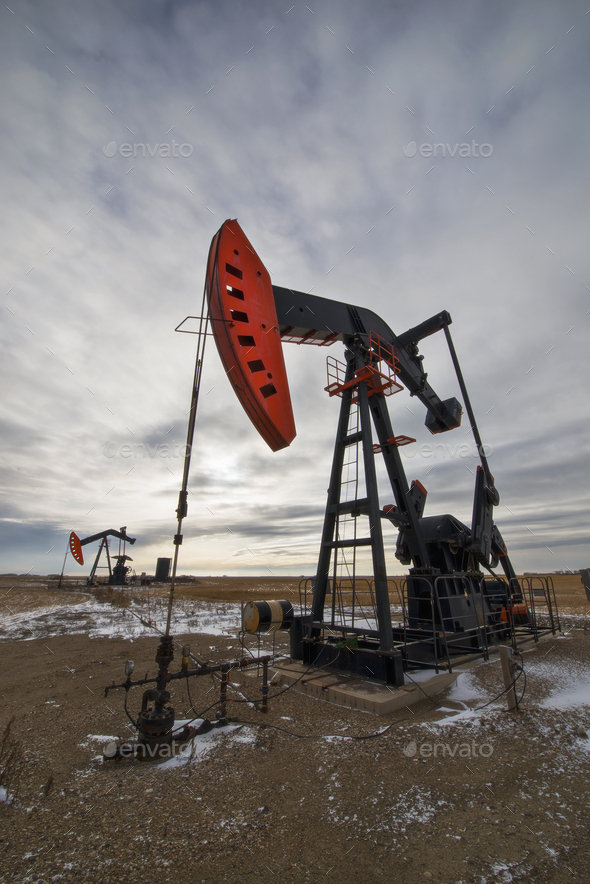 An oil pump jack at a drilling site for oil, an oil field in Saskatchewan.