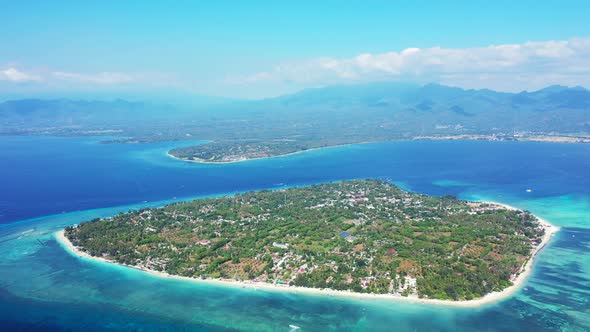 Big tropical island with resorts and villas for vacationers surrounded by white beach and blue turqu alt