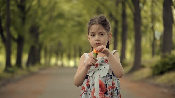 Young Children Enjoy Playing Funny Activity Together With Father. Little Girl Blowing Soap Bubbles. alt