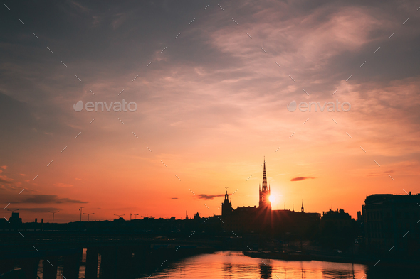 Stockholm, Sweden. Sunset Sun Shine Through Dark Silhouette Of Riddarholm Church In Stockholm - Stock Photo - Images