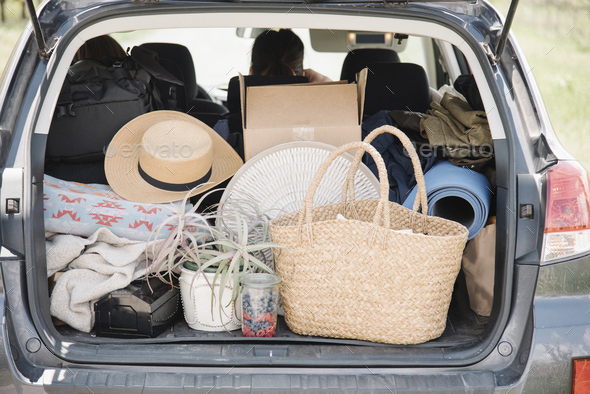 An estate car trunk full of bags and belongings.