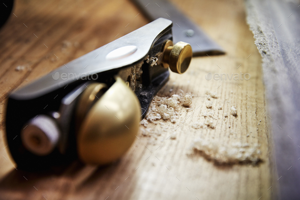 A wood plane with smooth handle and wood shavings. - Stock Photo - Images