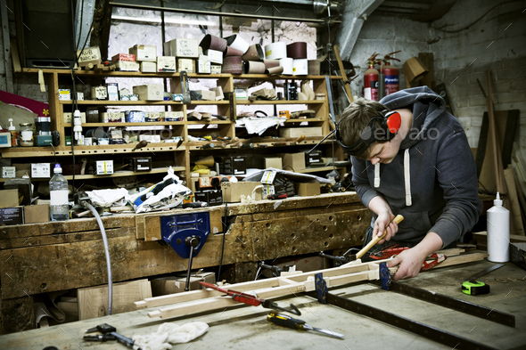 A man working in a furniture maker\'s workshop.