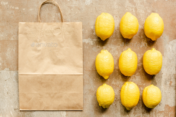 Flat Lay With Lemons Near Paper Bag on Weathered Surface