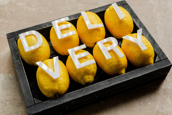 Word Delivery on Lemons in Wooden Black Box on Weathered Surface