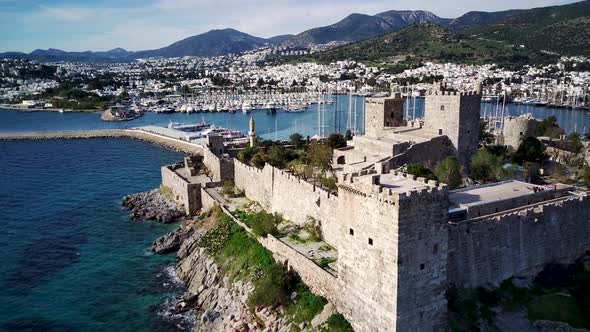 Amazing panoramic view from drone of full of yachts Bodrum harbour and ancient Kalesi castle. alt