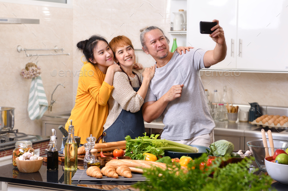 Family cooking in kitchen together - Stock Photo - Images