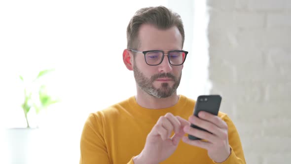 Portrait of Man Celebrating on Smartphone alt