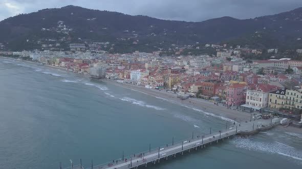 Aerial view of Alassio city and pier by the sea in Liguria, Italy alt