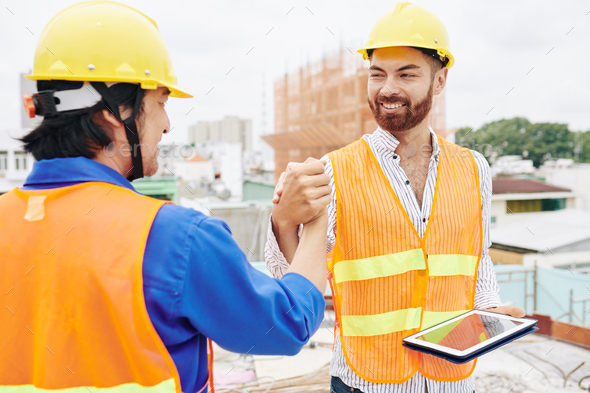 Contractor and builder shaking hands