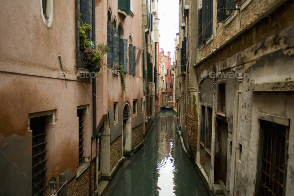 A view from above of a quiet backwater, a narrow canal with historic buildings rising from the water.