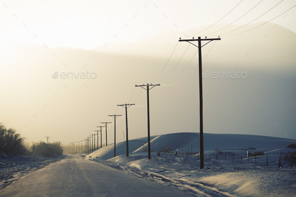Power lines reaching into the distance, with a mountain backdrop.
