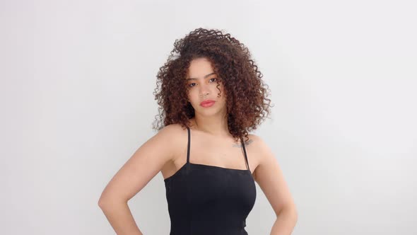 Mixed Race Black Woman with Freckles and Curly Hair in Studio on White Poses To a Camera
