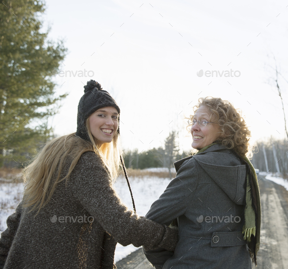 A Mother And Daughter Arm In Arm Walking Along A Path And Looking Over Their Shoulders Stock Images Page Everypixel