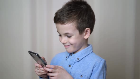 Happy Little Cute Boy Watching Funny Video in Social alt
