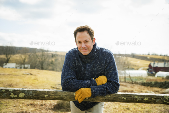 An Organic Farm in Winter in Cold Spring, New York State. A man working outdoors on the farm.