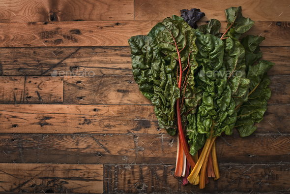 Organic vegetables,frehsly picked,and placed on a wooden board,chard