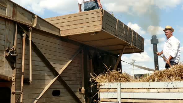 Steam engine driven threshing machines using belts alt