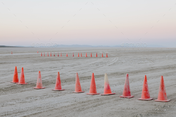 Row of traffic cones on the flat desert surface of Black Rock, Nevada.