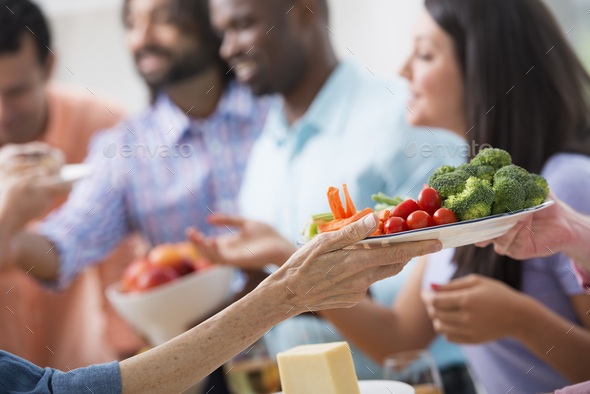 Working lunch, a salad buffet in an office,colleagues of mixed ages and ethnicities - Stock Photo - Images