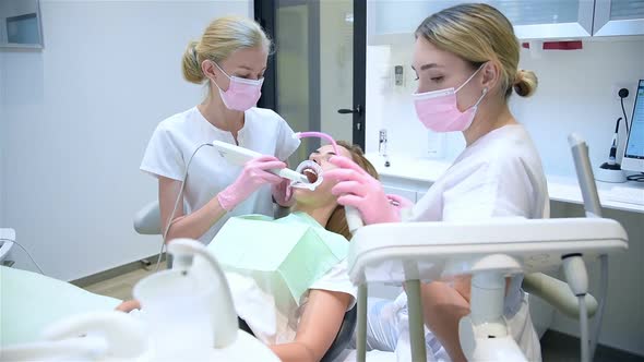 Dentist, Assistant And Patient's Scaning Teeth With Dental Intraoral Scanner