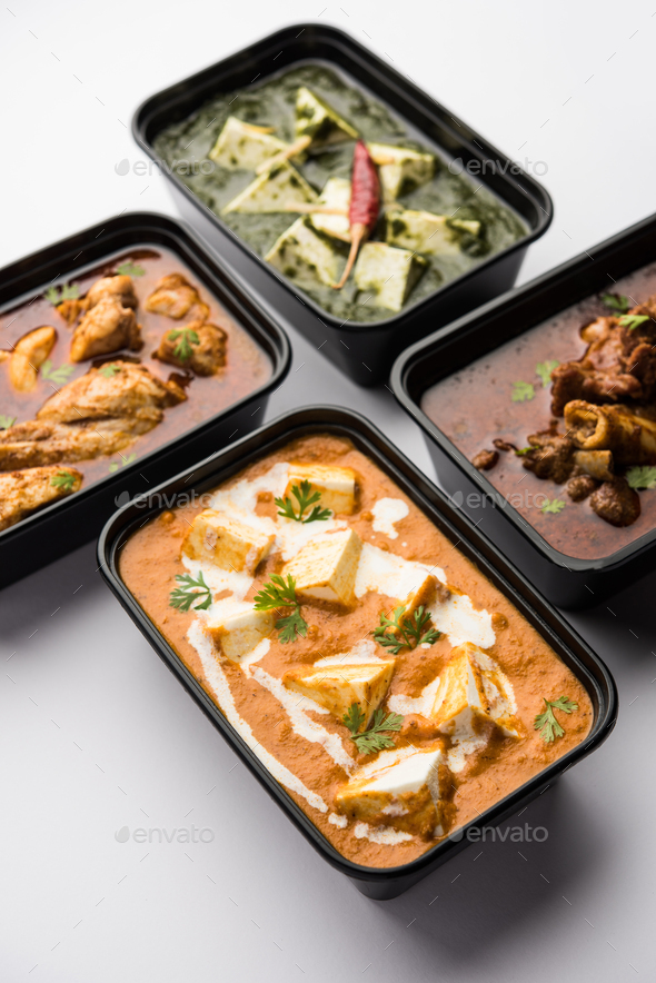 Online food delivery concept for Indian Restaurant showing plastic containers with food - Stock Photo - Images