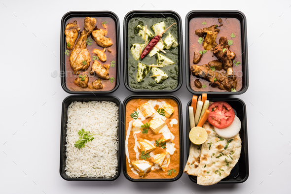 Online food delivery concept for Indian Restaurant showing plastic containers with food - Stock Photo - Images